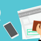 Vertrag vom Gründungszuschuss liegt auf einem Tisch.