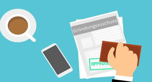 Vertrag vom Gründungszuschuss liegt auf einem Tisch.